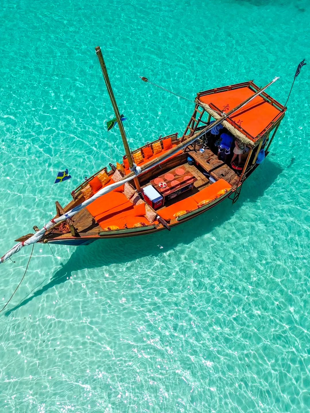A dhow viewed from above in clear turquoise water