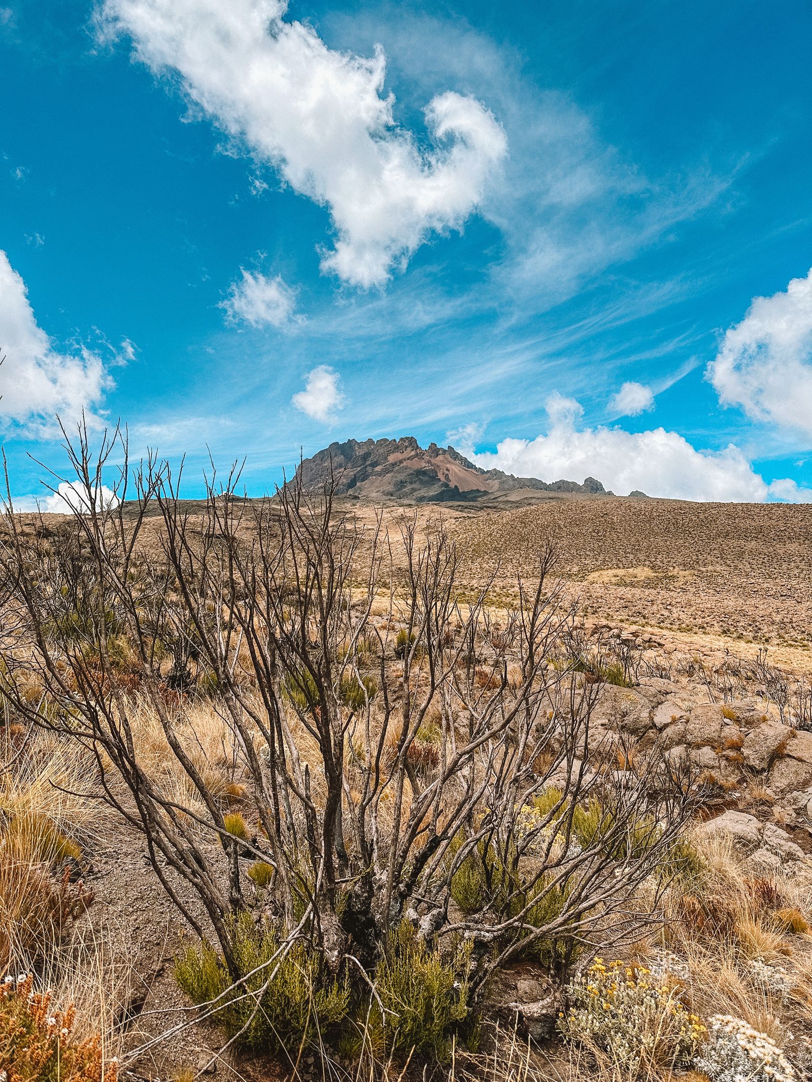 Rocky highland terrain beneath bright clouds