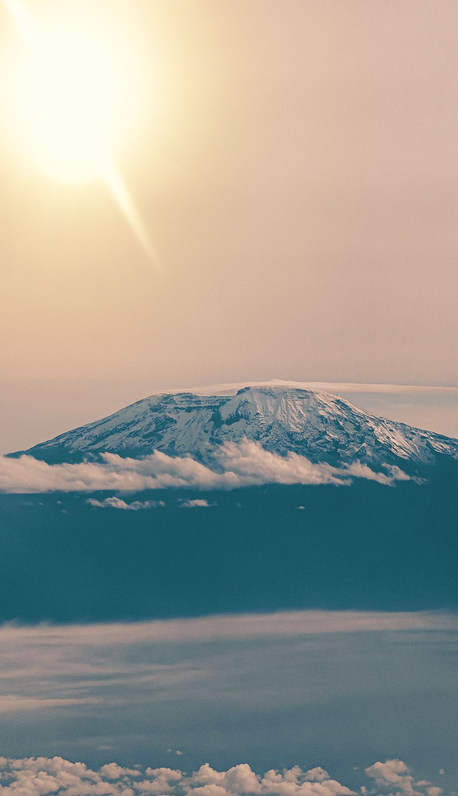 Kilimanjaro rising above cloud and warm light